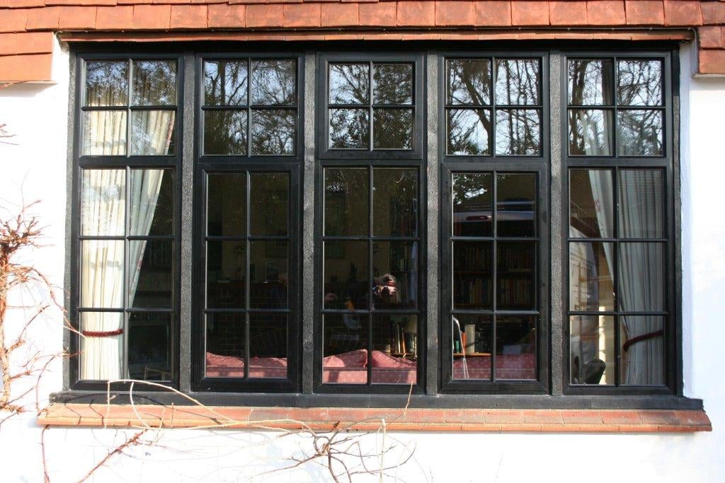 black powder coated window in hardwood subframe with external crittall bars. typical of country properties and cottages