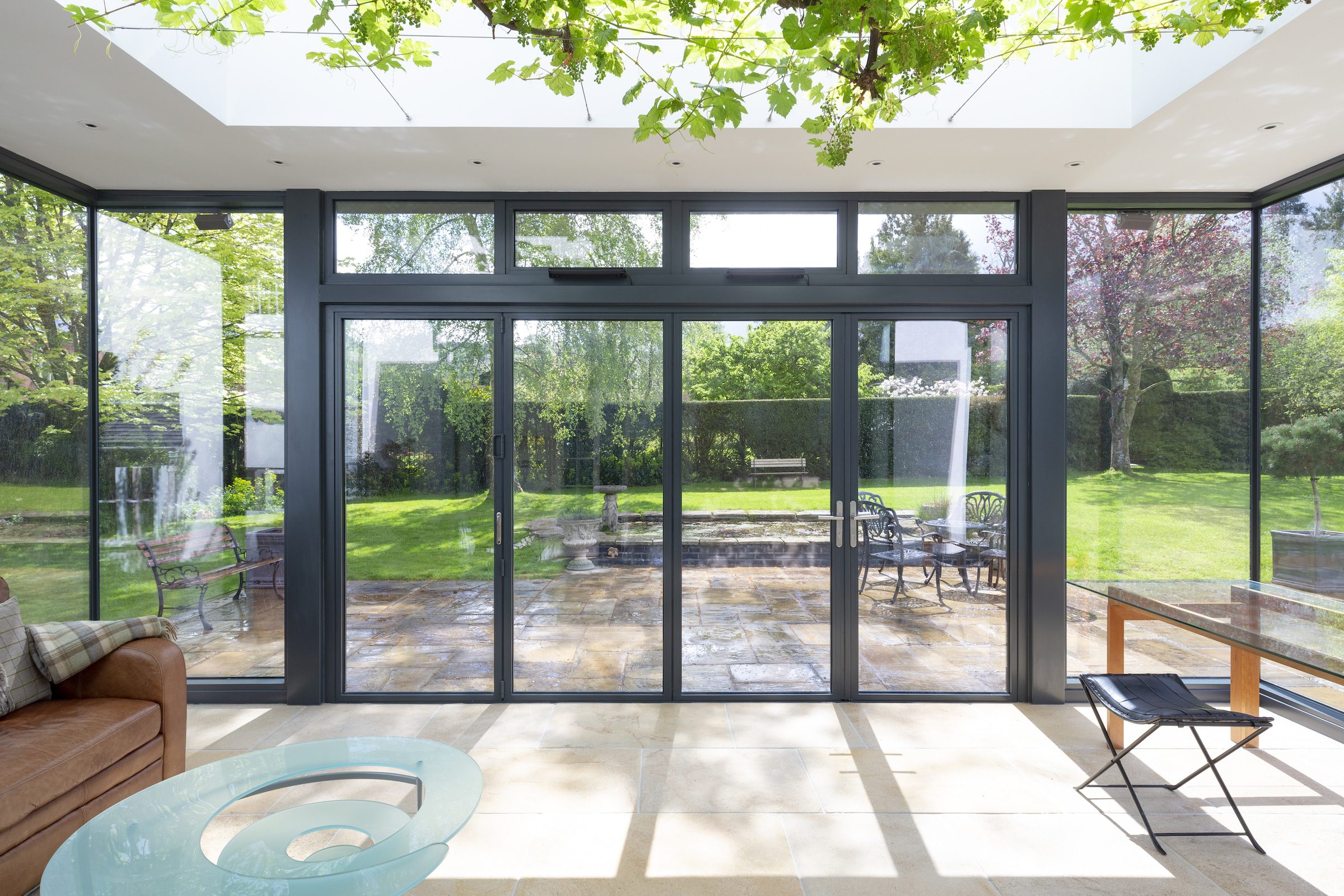 slimline visofold bifold doors in grey in a glass extension