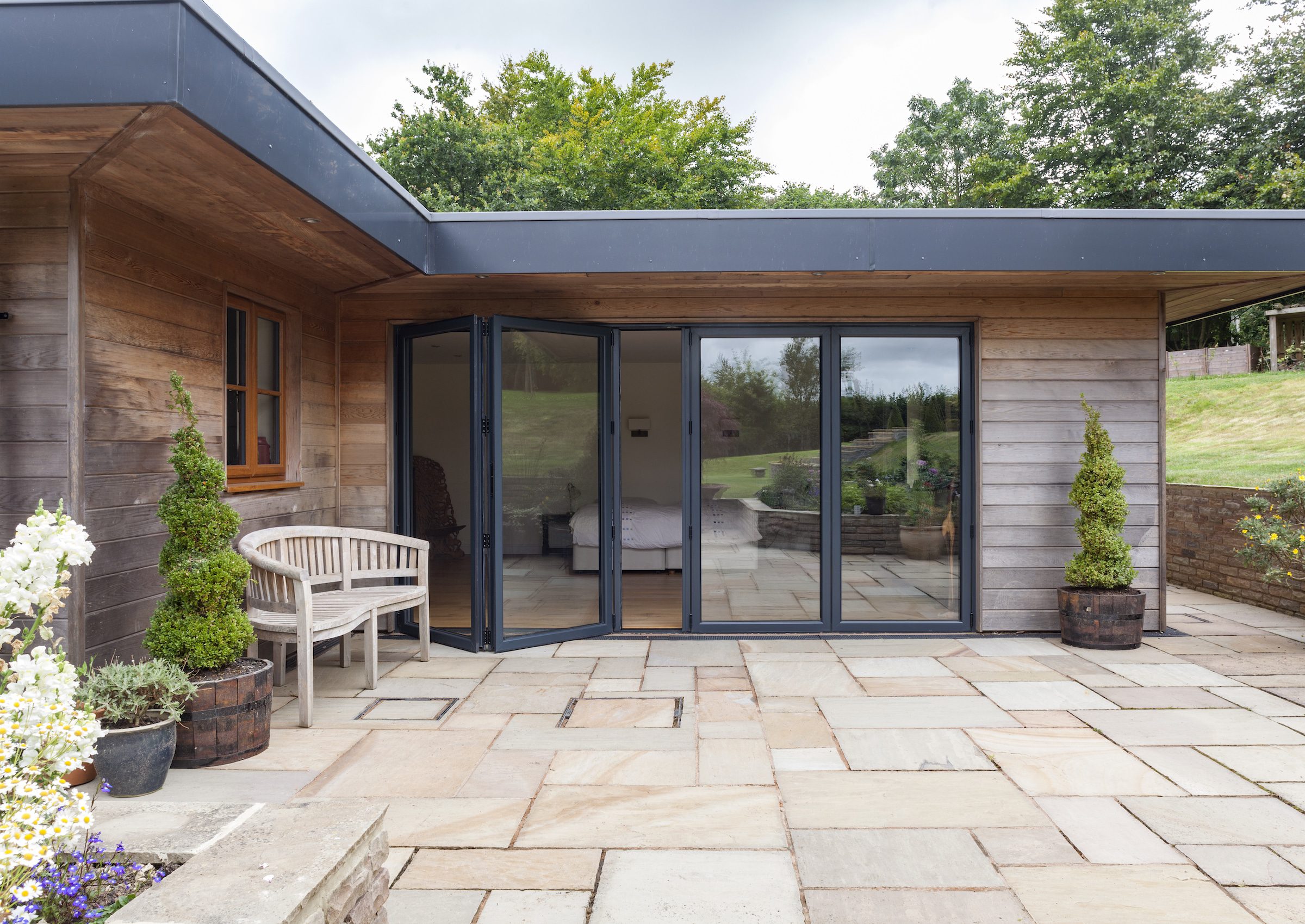 smart systems bifold doors installed in a modern extension with wood cladding