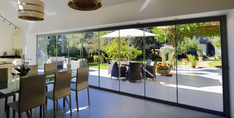 frameless glass curtains offer bifolding doors with less framing than typical aluminium bifolding doors