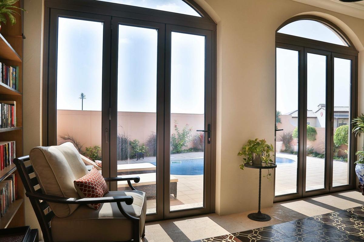 aluminium bifolding doors with cured window above. 