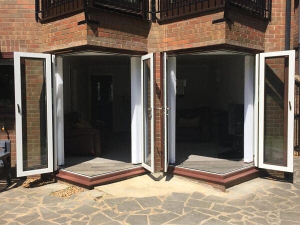 open corner white bifold doors in a new build home