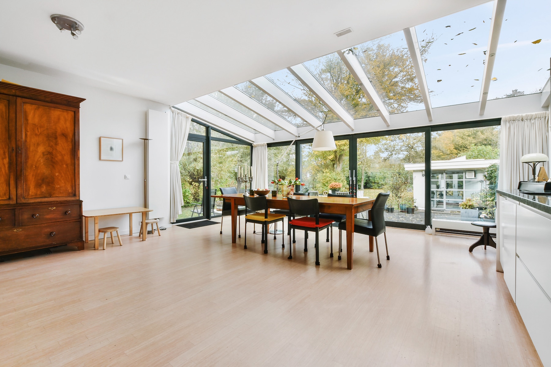 aluk sliding patio doors in a glazed extension under a glass roof