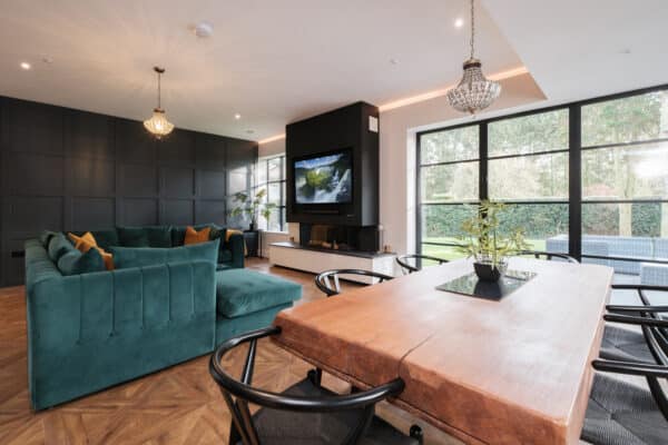 lounge diner with wood floors and steel look bifold doors