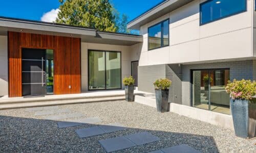 windows and doors for new build homes showing contemporary home exterior on lakeshore with flat roof and large feature windows