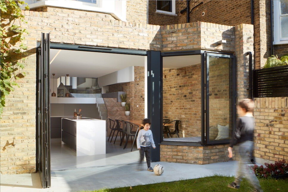 sunflex bifold window showing little boy walking through a set of doors