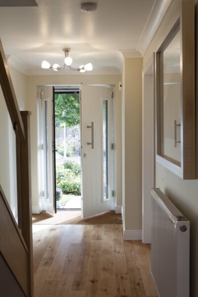 internal view of solidor composite doors partially open in a hallway