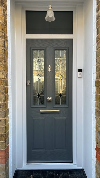 composite door in a grey slab with white pvcu frame and toplight.