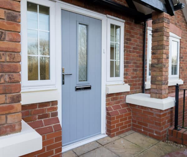 comp doors duck eat blue composite door in a porch.