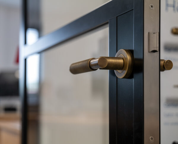 close up of black door with brass handle