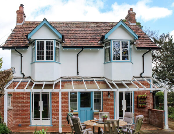 picture of a traditional house with white steel look windows and doors