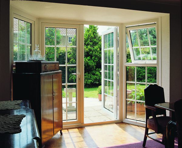 rehau french doors with window bays in a bright lounge. doors open to patio