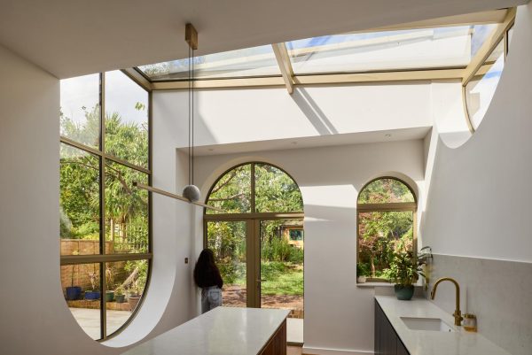 curved bespoke gold aluminium windows in a kitchen extension