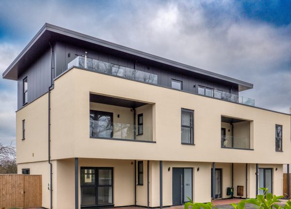 modern house with penthouse style top floor and grey schüco windows and doors.