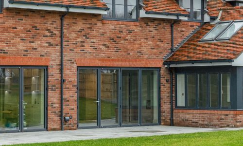 bifold doors in a large detached house with lawn