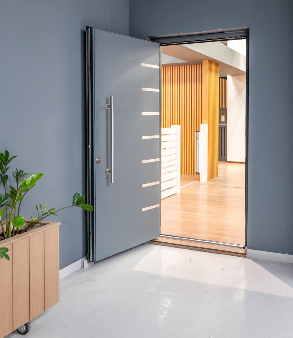 alumil sd95 front door in a showroom seteting with plant pot