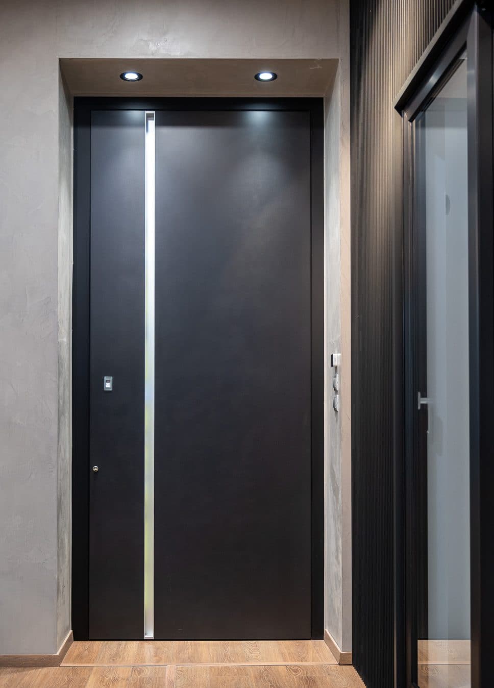 alumil front doors closed beside a black sliding door