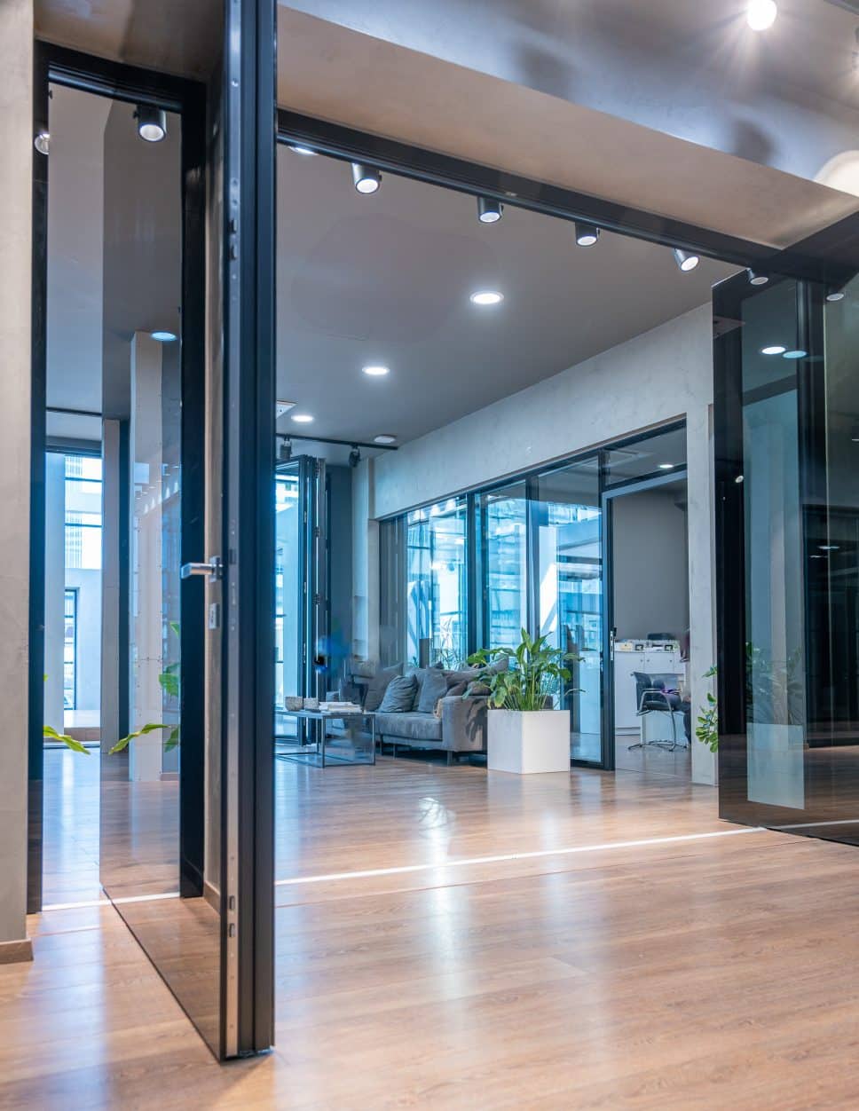 alumil front doors pivot open in a showroom reception