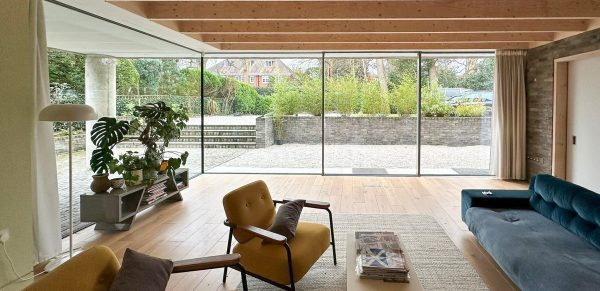 alumil aluminium showing ultra slim sliding doors in a contemporary lounge. 