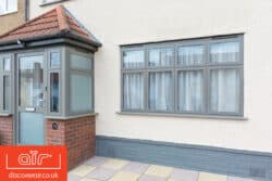 grey aluminium windows with a matching grey door