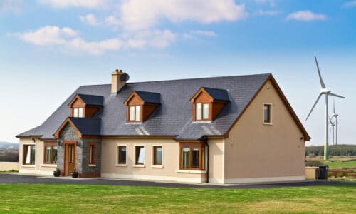 new home with eco-friendly windows in front of turbines