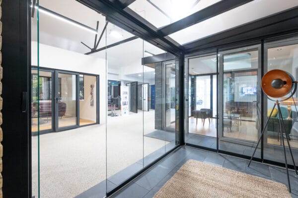 door and window showroom showing sliding and bifold doors against a backdrop of more bifolds and windows