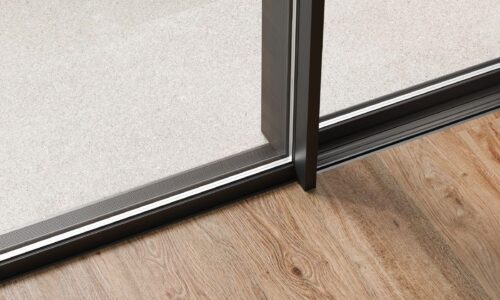 schüco ase 51 pd close up of door centre interlock on wood floor with flush track.