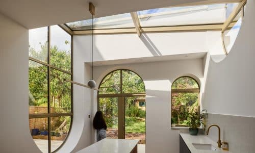 curved bespoke gold aluminium windows in a kitchen extension