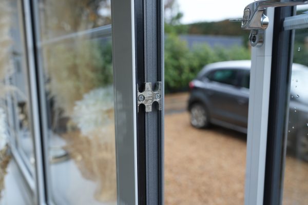 close up of open window showing handle and locking espagnolette
