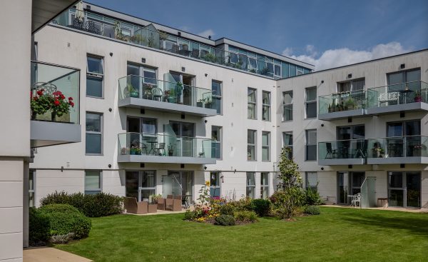 garden area in modern apartment building with cortizo casement windows and french doors. 