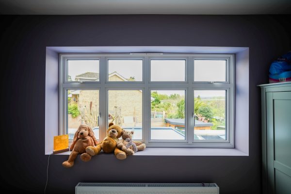 cortizo casement windows inside view white with toys on the cill.