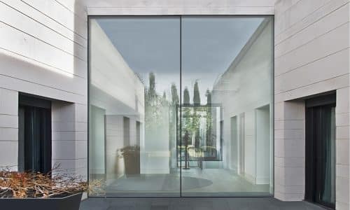 glidline gs 15 sliding door in a stone and marble opening