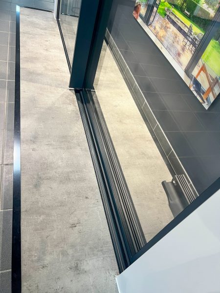 overhead shot of invisoglide sliding door track with level floor either side. 