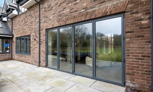 picture of a new bifold door next to an existing window