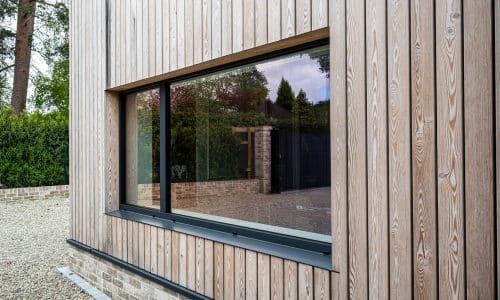 cortizo hidden sash window in a cedar clad opening