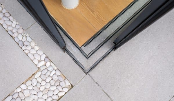 top view of a tiled in track system on an open corner set of doors