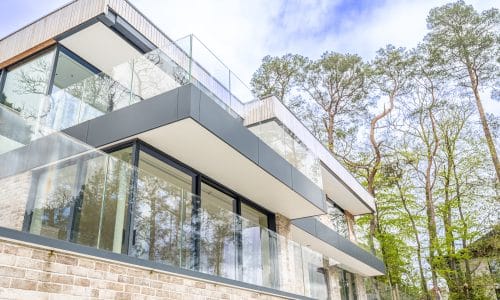 outside picture of modern house with many sliding doors and glass balustrades