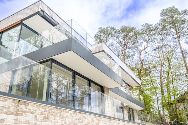 outside picture of modern house with many sliding doors and glass balustrades