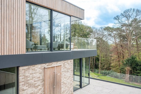 outside view of luxview slide 54 sliding doors with fixed and open panels within cladding and hidden frames.