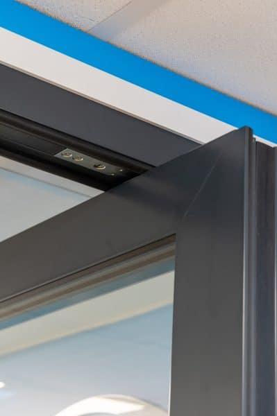 close up of top pivot on an aluminium door