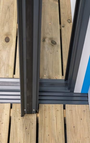 close up view of bottom pivot on an aluminium door
