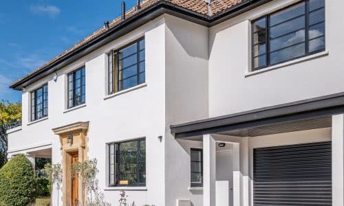 picture of white rendered house with steel-look windows