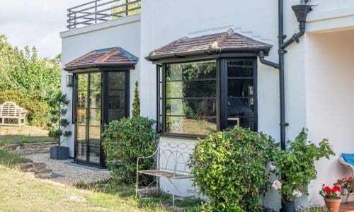 white house with crittall® inspired bay windows and doors