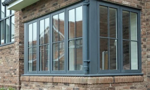 grey bay window showing grey textured dummy casement and sash windows