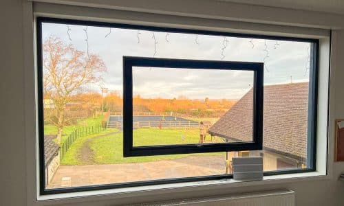 frameless window in a bedroom showring opening sash fitted in glass