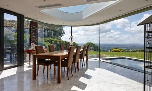 frameless windows in a coastal location with curved glass