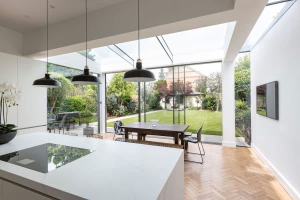 frameless sliding doors with frameless roof in a kitchen extension