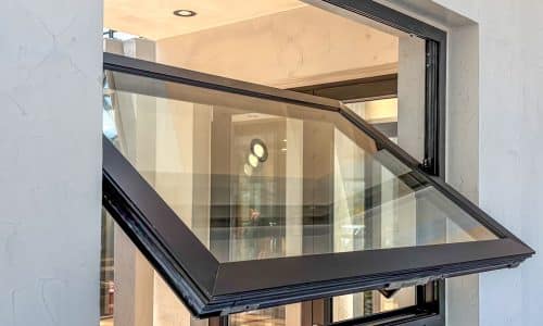 alumil black pivot opening windows in a showroom