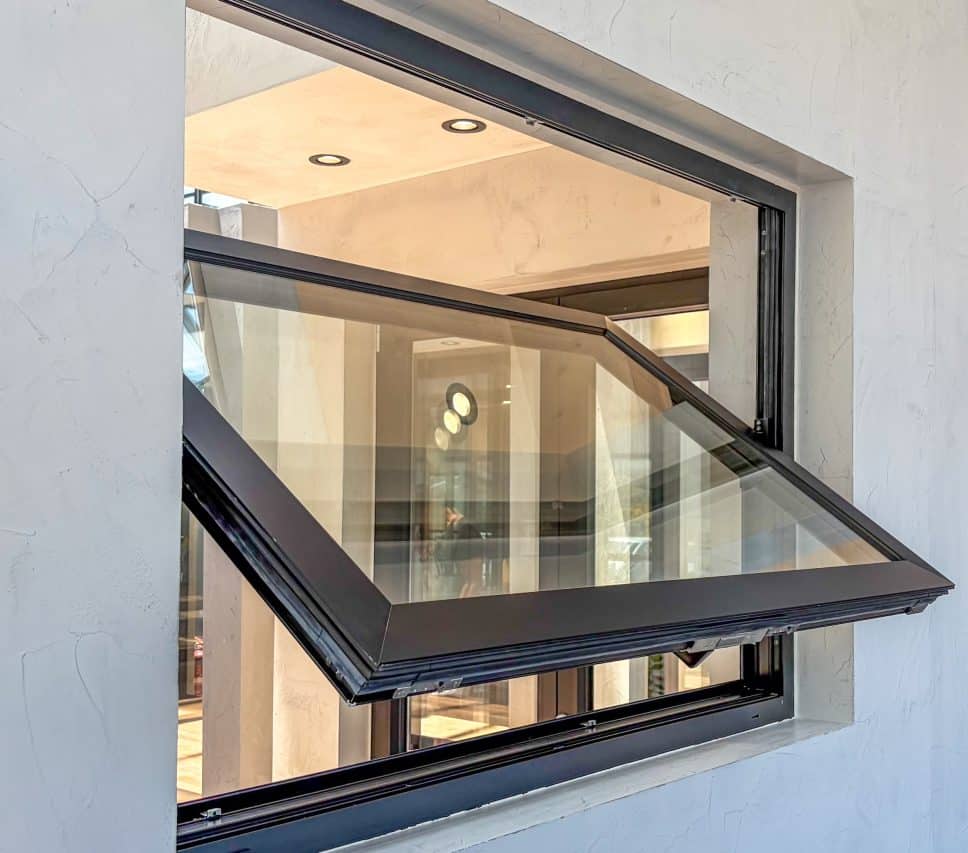 alumil black pivot window in a showroom